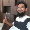 Mohammed Asif sitting in his office thumbs up asifindia
