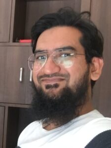Mohammed Asif sitting in his office thumbs up asifindia